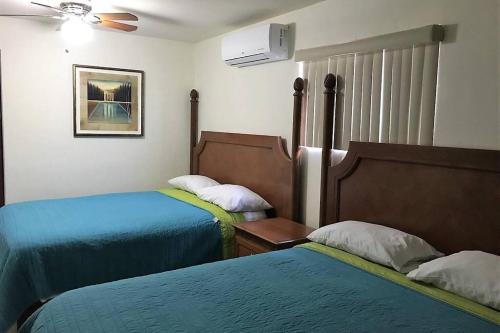 Ένα ή περισσότερα κρεβάτια σε δωμάτιο στο Rubí Joyas del Mar Bahia de Kino