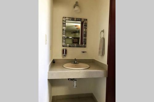 a bathroom with a sink and a mirror at Rubí Joyas del Mar Bahia de Kino in Bahía Kino