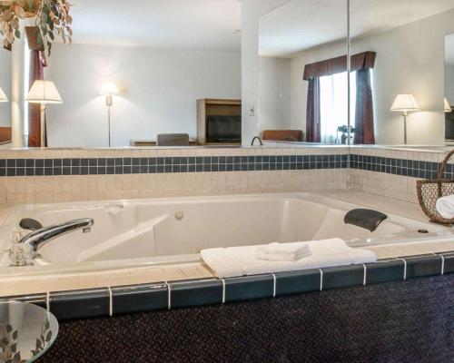 a large bathroom with a bath tub with towels at Quality Inn Hudsonville South in Hudsonville
