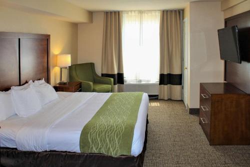 a hotel room with a bed and a television at Comfort Inn & Suites St Louis - Chesterfield in Chesterfield