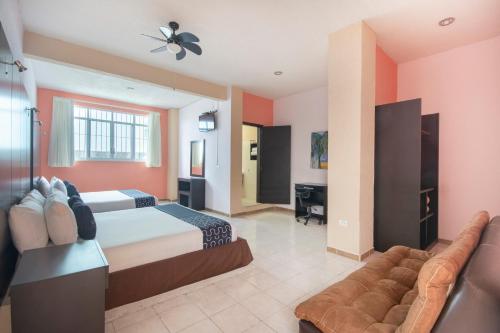 a large bedroom with a bed and a couch at Hotel Spa Shalam in Coatepec