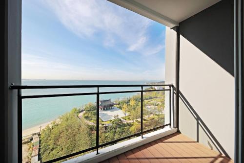 a balcony with a view of the ocean at Airsky Hotel Incheon in Incheon