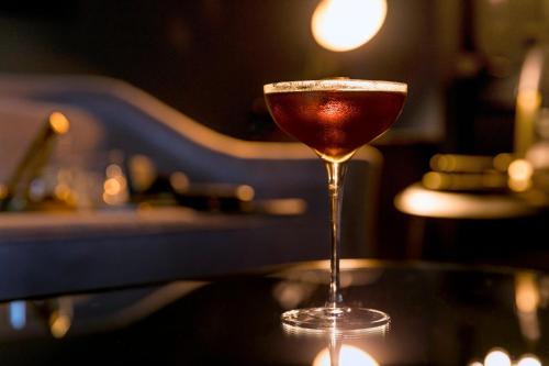 a martini glass sitting on top of a table at Hotel AKA Boston Common in Boston
