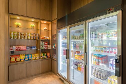 a refrigerator with its doors open in a store at Hotel Amber Pattaya in Pattaya Central