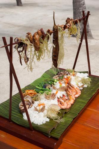 a plate of food on top of a banana leaf at Bohol Beach Club in Panglao