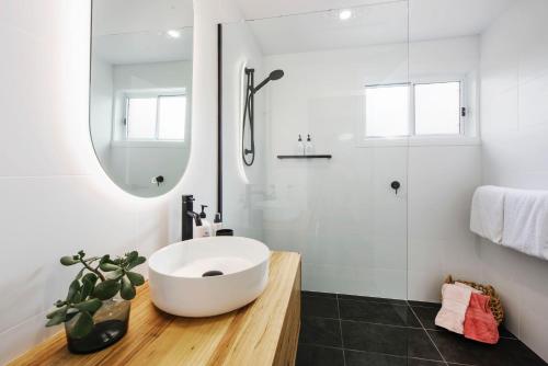 a bathroom with a white sink and a shower at The Laneway in Mudgee