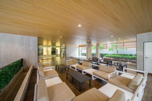 a lobby with couches and tables in a building at Hotel Amber Pattaya in Pattaya Central