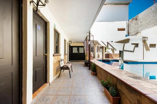a corridor of a building with a swimming pool at HOTELES CATEDRAL Torreón in Torreón
