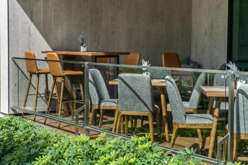 a group of chairs and tables on a balcony at Hotel Amber Pattaya in Pattaya Central