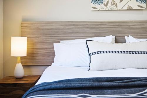 a bedroom with a large bed with a wooden headboard at The Laneway in Mudgee