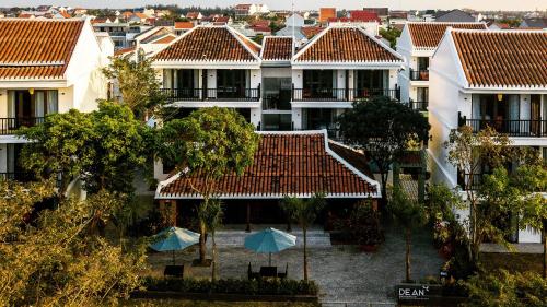an aerial view of a building with umbrellas at De An Hotel in Hoi An