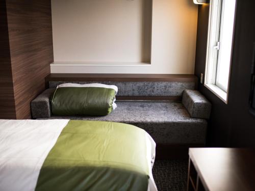 Postel nebo postele na pokoji v ubytování Super Hotel Mito