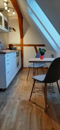 a kitchen with a table and chairs in a room at Ferienwohnung Buchtal in Albstadt