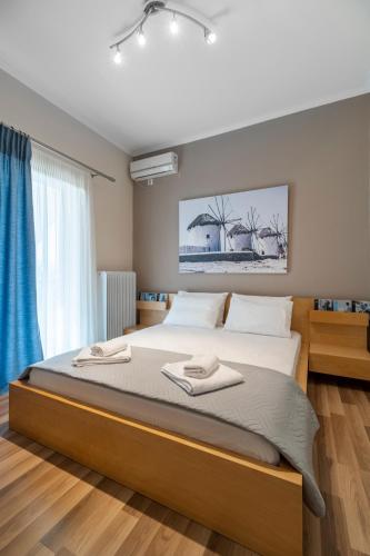 a bedroom with a large bed with two towels on it at Castellano Monemvasia in Monemvasia