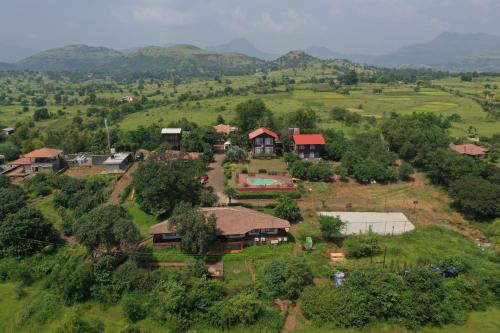 an aerial view of a house on a hill at Jayshin Lake Vaitarna Resort - Igatpuri in Igatpuri