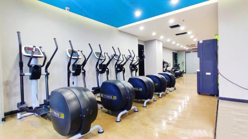 a row of cardio machines in a gym at Yantai Meiya International ApartHotel (Previous Ramada Plaza) in Yantai