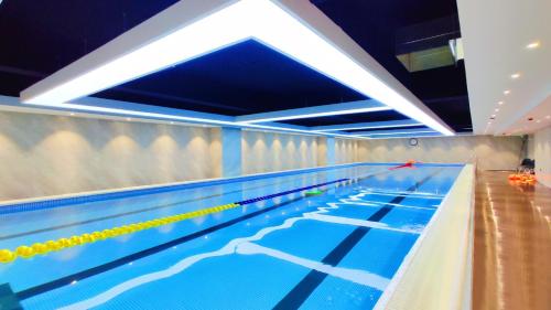 an empty swimming pool with a lanes at Yantai Meiya International ApartHotel (Previous Ramada Plaza) in Yantai