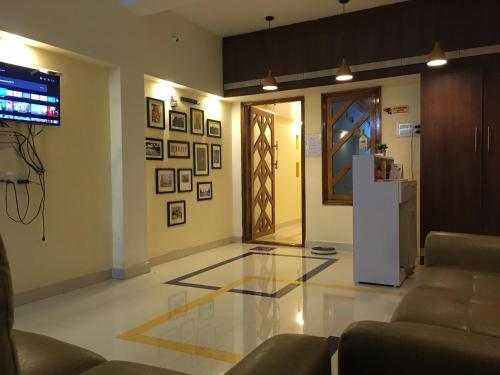 a living room with a glass floor and a door at Grand Suites Srirangam in Tiruchchirāppalli