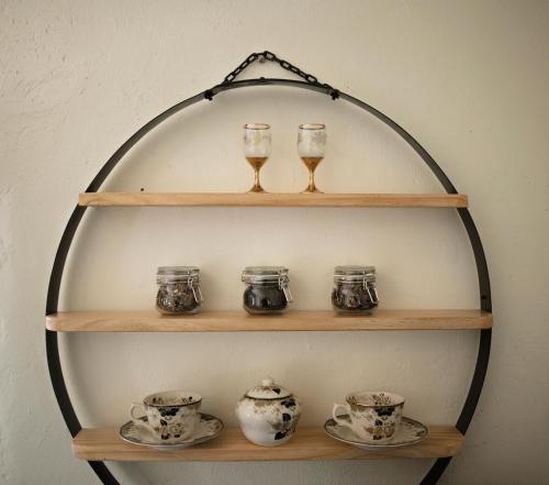 a shelf with glasses and tea cups on it at Second Valley Cottages and Lodge in Second Valley