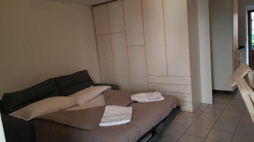 a bedroom with a bed with pillows and a cabinet at Locanda al Crap in Tresivio