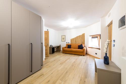 a living room with a refrigerator and a couch at Agriturismo Cà Gianin in Vervio