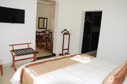 a hotel room with a bed and a tv at Royal Palace Hotel in Juba