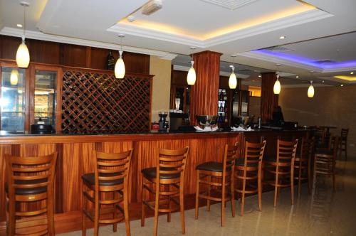 a bar with wooden stools at a restaurant at Royal Palace Hotel in Juba