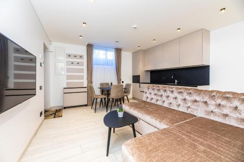 a living room with a couch and a table at M50 Apartments in Palanga