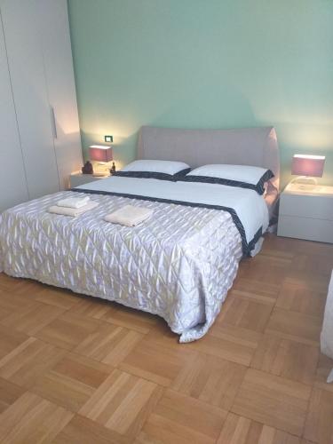 a bedroom with a large bed and a wooden floor at Lux in Padova