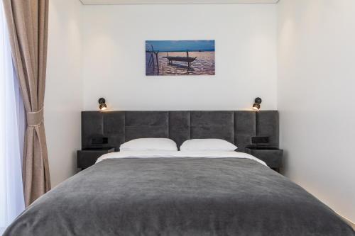 a bedroom with a large bed with two pillows at M50 Apartments in Palanga