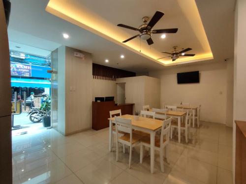 a dining room with tables and a ceiling fan at 538 Dormitel in Manila