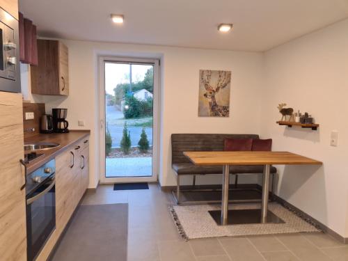 a kitchen with a wooden table and a dining room at wohnung-nummer-1 in Pielenhofen