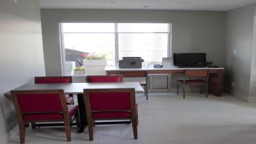 a room with a desk with a computer and chairs at Holiday Inn Express Hotel & Suites Somerset Central by IHG in Somerset