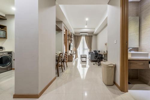 a kitchen and living room with white walls at Grande Valore Hotel Cikarang in Cikarang