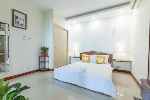 Giường trong phòng chung tại Bai Sau Apartment