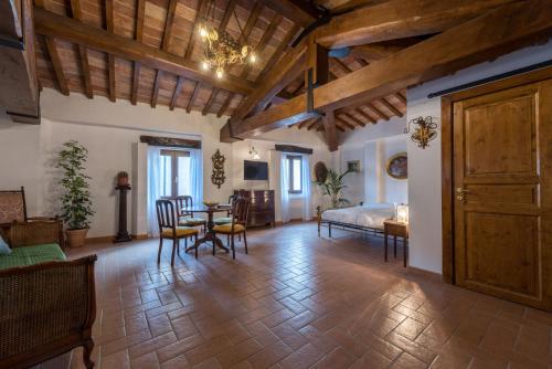 a living room with a bed and a table and chairs at Lemon Tree Boutique Guest House in Todi
