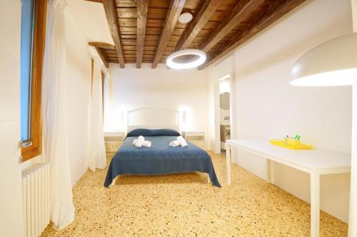 a small bedroom with a bed and a desk at DolceVita Apartments N. 479 in Venice