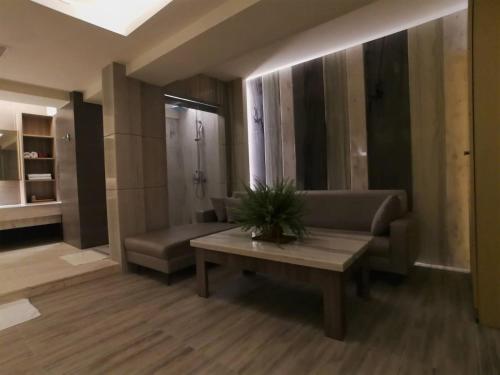 a living room with a couch and a table at Michelle hotel in Yuanlin