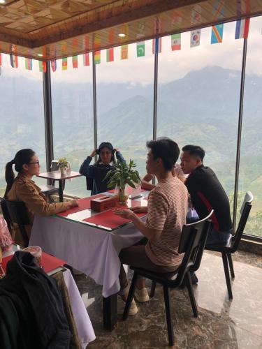 a group of people sitting at tables in a restaurant at Sapa Valley view hotel in Sa Pa