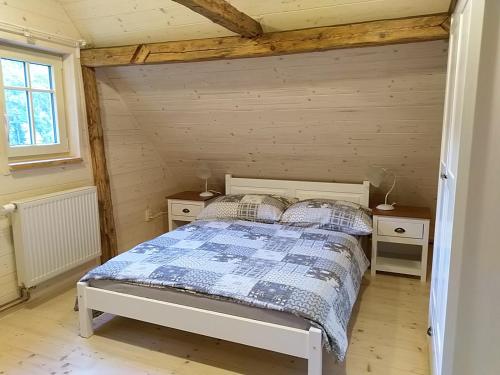 a bedroom with a bed and two night stands at Chaloupka Jizerské hory in Janov nad Nisou