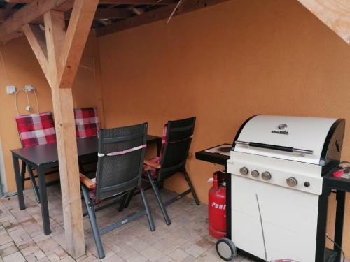 kuchnia z kuchenką, stołem i krzesłami w obiekcie Apartman Miky w mieście Dürnholz