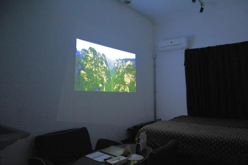a room with a bed and chairs and a window at The Wonder At Stay-Bentencho- in Osaka
