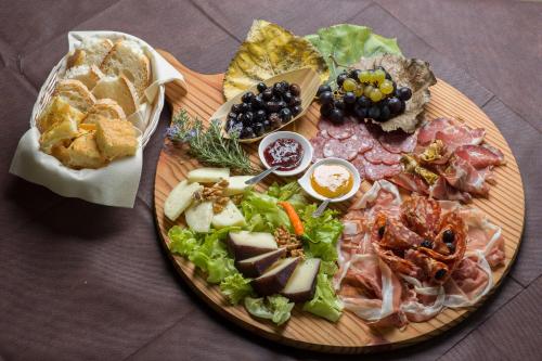 a plate of food on a table with a salad at Le Terre di Maluk in Monte San Vito