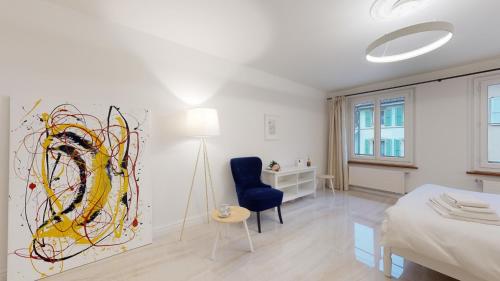 1 dormitorio con 1 cama y una pintura en la pared en DA-DA Gallery Appart - modern and luxury studio in Boudry, en Boudry