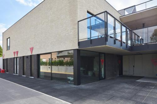 an external view of a building with a balcony at Café Coureur Borgloon in Borgloon