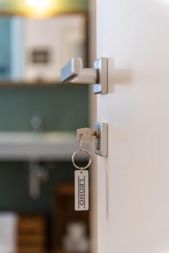 a lock on a door with a tag on it at Il Treno dei Sogni - Bed & Relais in Conselve