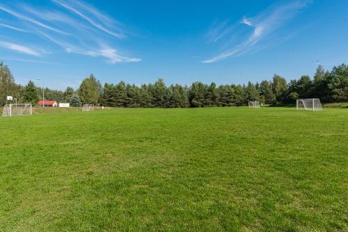 a large field with a soccer field with a goal at Ośrodek Wypoczynkowy Kalwa in Pasym