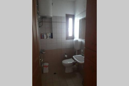 a small bathroom with a toilet and a sink at Efis house in Kalívia