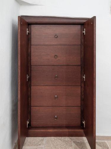 a wooden chest of drawers in a room at Trulli Uliveto Acquafonda in Alberobello