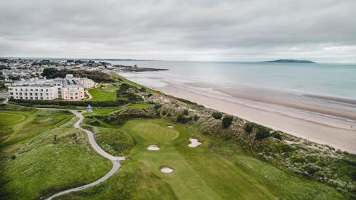 an aerial view of a golf course next to the beach at Portmarnock Resort & Jameson Golf Links in Portmarnock